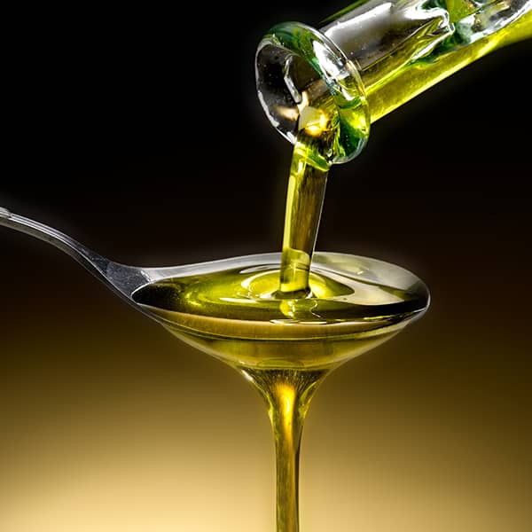 oil pouring onto a spoon