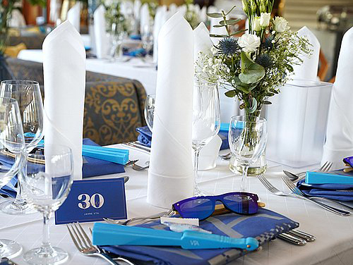 place setting with blue and white theme at an event