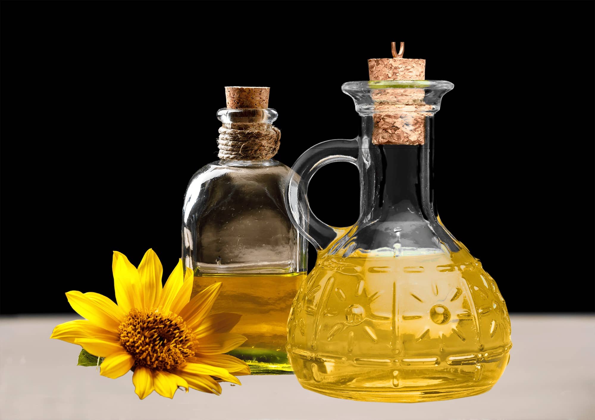 yellow flower and two glass bottles of oil